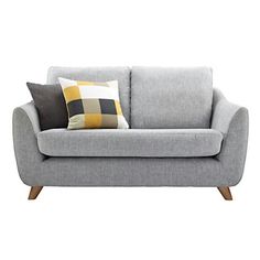 a gray couch with two pillows on it