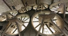 the inside of an old building with many large wheels on it's sides and windows