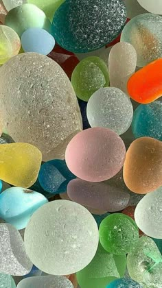 many different colored glass pebbles on top of each other