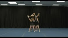 three girls are doing a handstand on the floor