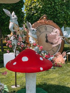 a red mushroom sitting on top of a lush green field next to a large clock