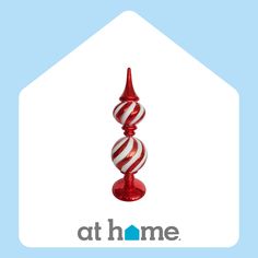 a red and white striped glass candle holder with the words athome on it