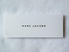 a white piece of paper with the word marc jacobs on it and black lettering