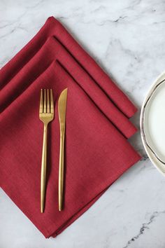 a red napkin with gold fork and knife on it