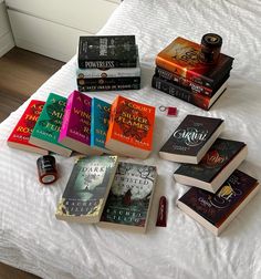 a bed topped with lots of books on top of it