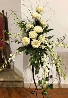 a vase filled with white flowers on top of a table