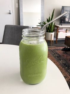 a green smoothie in a mason jar on a table