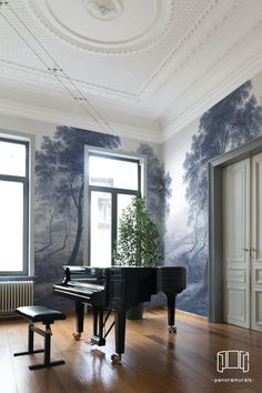 an empty room with a piano in the center and wallpaper on the walls behind it