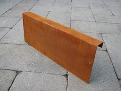 a wooden bench sitting on top of a sidewalk