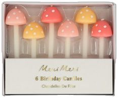 six birthday candles in a box with polka dots on the top and mushrooms on the bottom