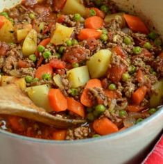 a pot filled with meat and vegetables on top of a table