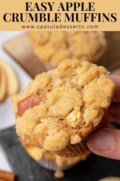 a hand holding up an apple crumble muffin