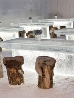 the tables and benches are covered in ice, snow and frosty material with fur on them