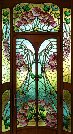 a stained glass door with flowers on it