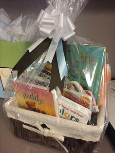 a basket filled with books on top of a table next to a bag and some other items