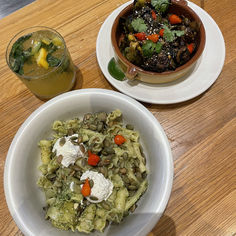 two bowls of food on a wooden table