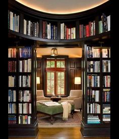 a room filled with lots of books and furniture