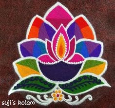 a colorful flower with leaves on it and the words suji's kolam written below