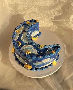 a blue cake with stars and moon designs on it