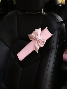 a pink bow on the back seat of a car