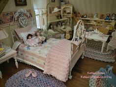 a doll house bedroom with dolls on the bed and rugs around the bedspread