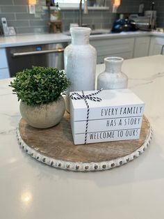 a couple of vases sitting on top of a wooden tray next to a sign