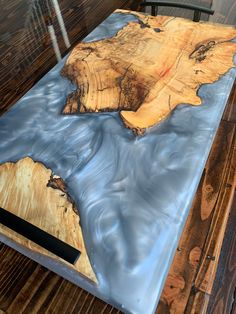 the table is made out of wood and has blue paint on it's surface