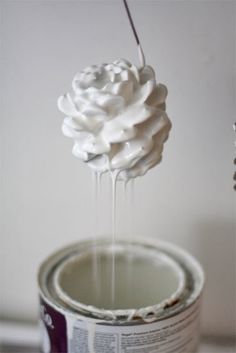 a paint can being filled with white whipped cream