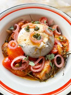 a white bowl filled with food on top of a table