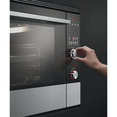 a person is opening the door to an oven