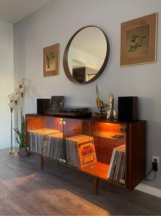 a record player is sitting on top of an entertainment center in the corner of a room