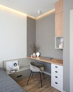 a bed room with a neatly made bed next to a desk and drawers on the wall