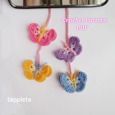 three crochet butterflies hanging on a rope next to a mirror with the words crochet pattern pdf