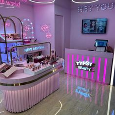 the inside of a beauty store with neon lights