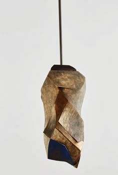 a piece of wood that is hanging from a ceiling fixture with a metal bar attached to it