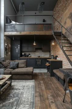 a living room filled with furniture next to a loft style kitchen and dining area on top of a hard wood floor