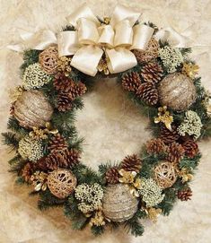 a christmas wreath with pine cones and ornaments