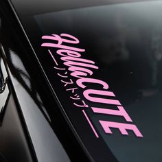 the side of a car with pink lettering on it