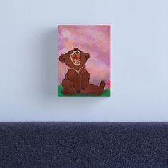 a cartoon bear sitting on the ground with his mouth open and tongue out canvas print