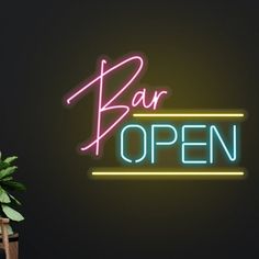 a neon sign that says bar open next to a potted plant