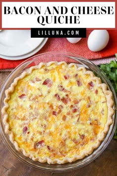 bacon and cheese quiche in a glass pie dish on top of a wooden table