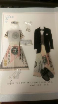 a paper doll with money and dress on it's display case, next to a pair of shoes