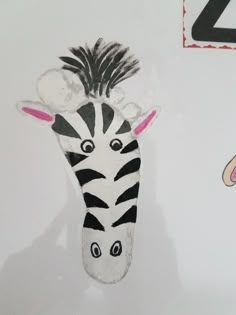 a drawing of a zebra's head is shown next to a child's hand