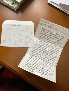 a note sitting on top of a wooden desk