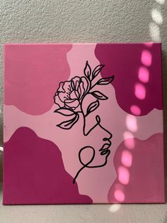 a pink and white painting with a rose in the middle on it's face