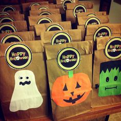 bags with halloween decorations on them are sitting on a table in front of other bags