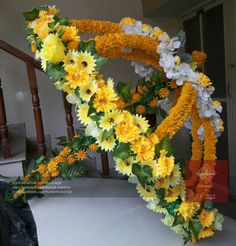 yellow and white flowers are arranged on the banister