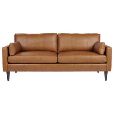 a tan leather couch with wooden legs