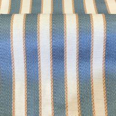 a blue and white striped fabric with brown stripes on the bottom half of it's edges