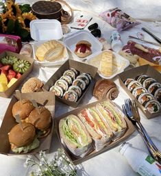 an assortment of sandwiches and pastries on a table